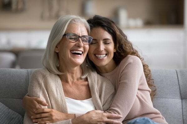 assisted-living-mother-daughter-laughing-together-couch-2